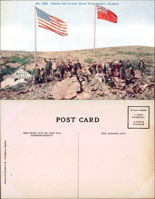 Crowd under American and British flags at White Pass Summit Alaska