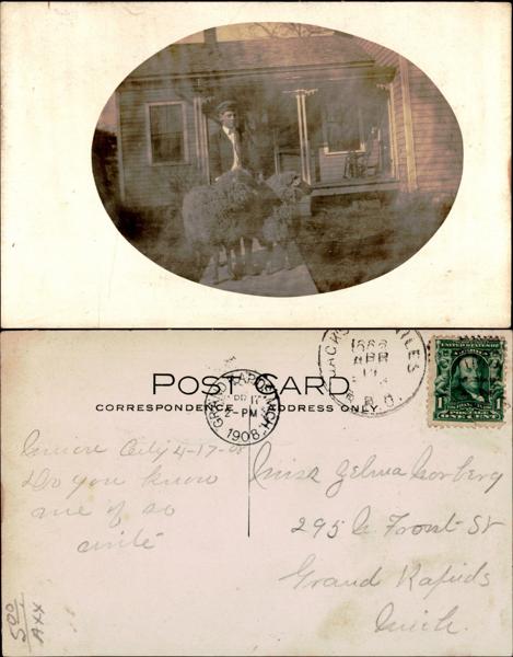 Boy with sheep in front of a house, historic photo.